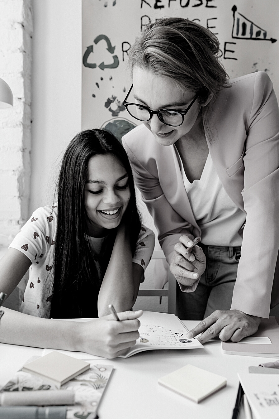 Woman in Pink Blazer Teaching a Girl 